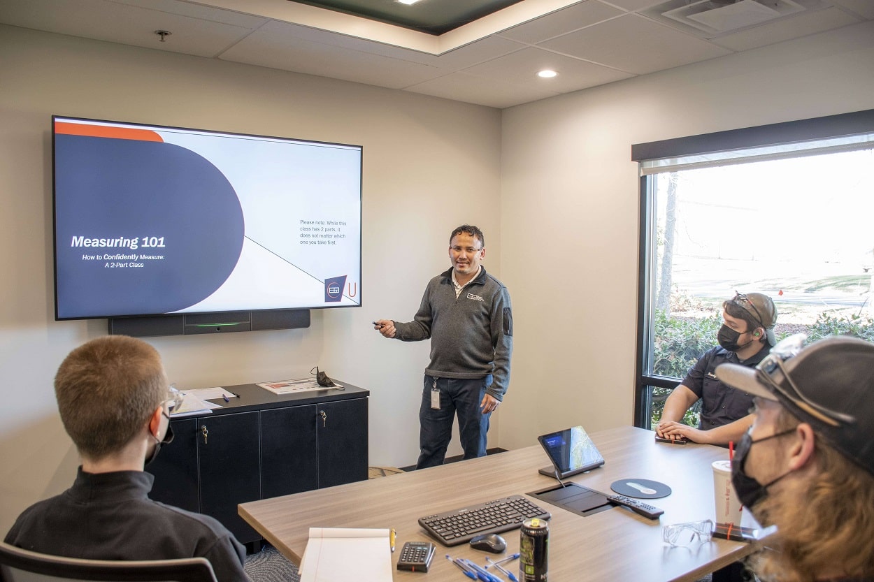 man pointing at a screen during training presentation