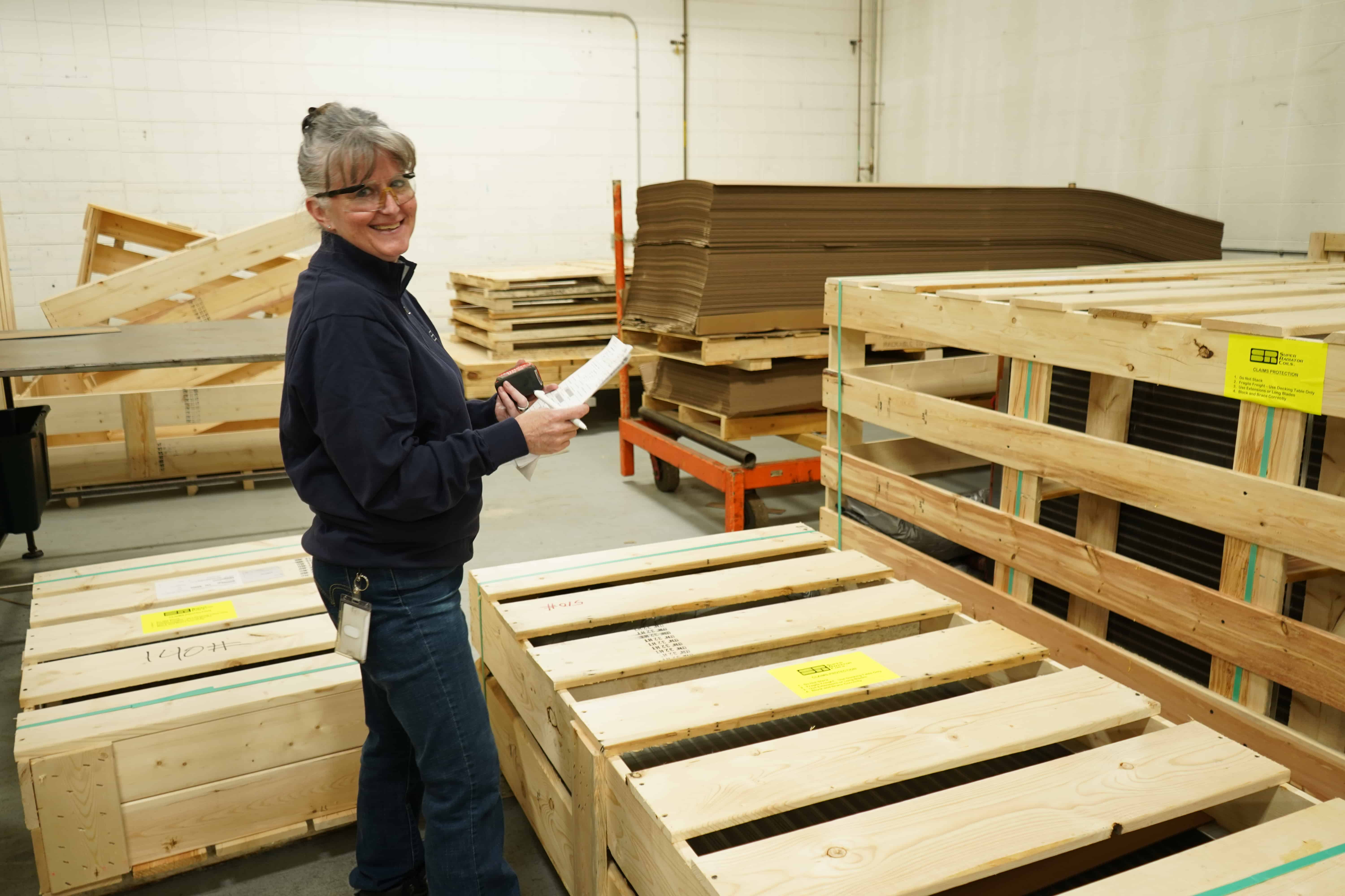 woman with clipboard smiling 