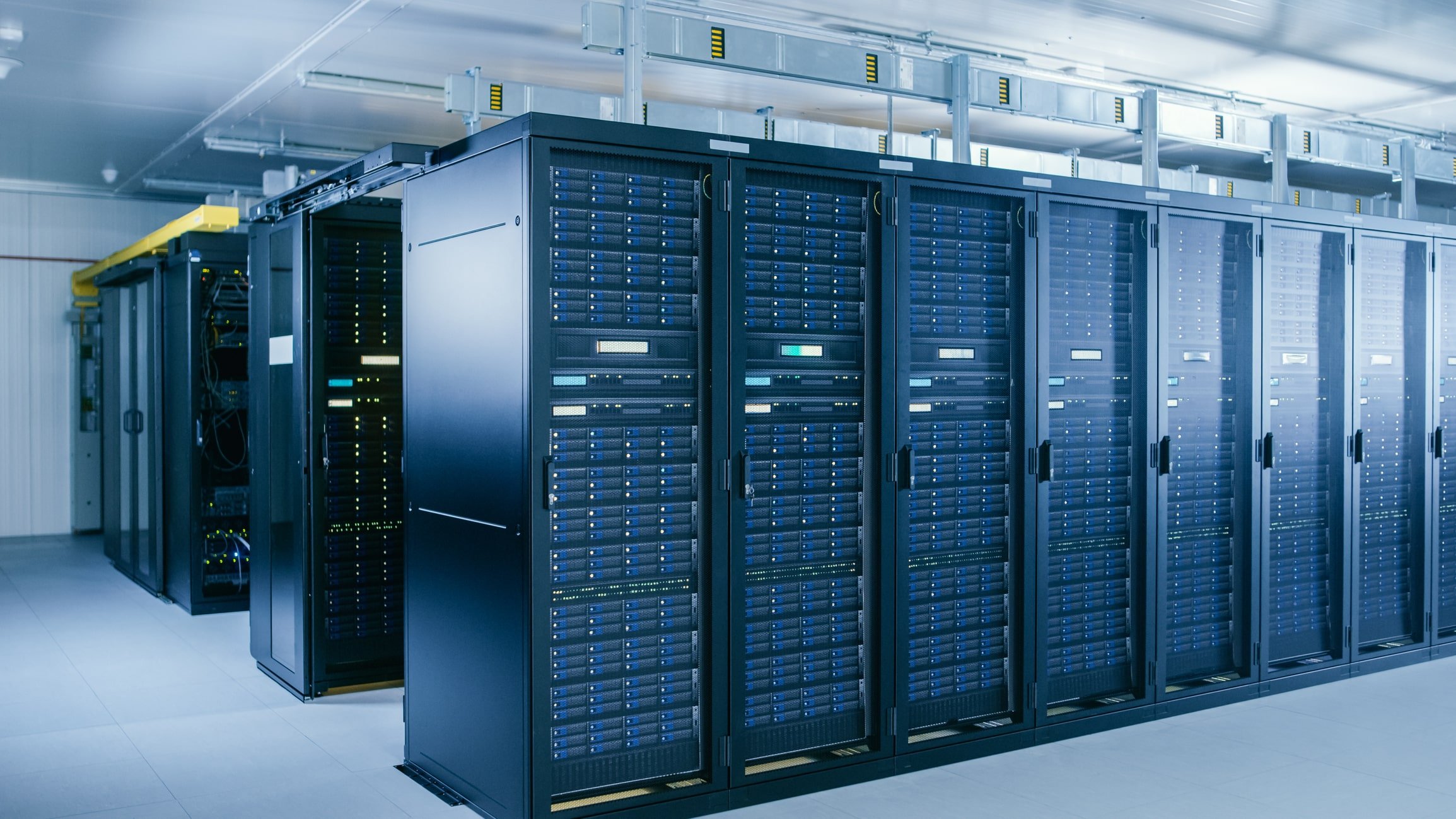 rows of black computer serves inside a datacenter