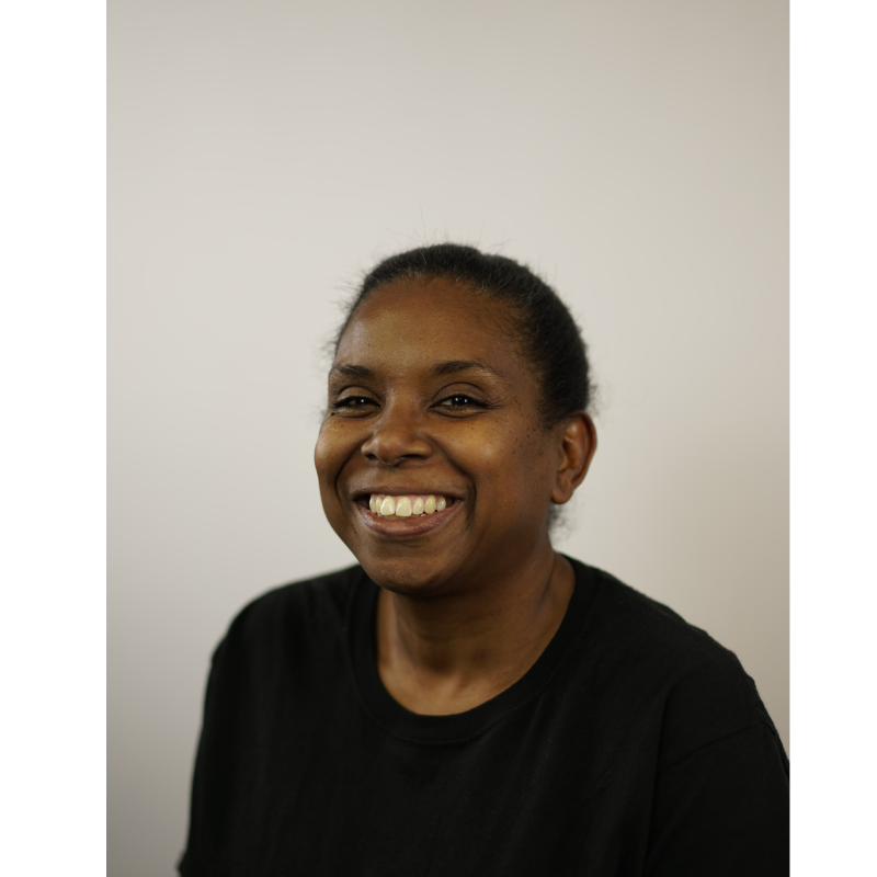 woman in black shirt smiling for company headshot