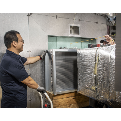 man installing heat exchanger into wind tunnel for testing
