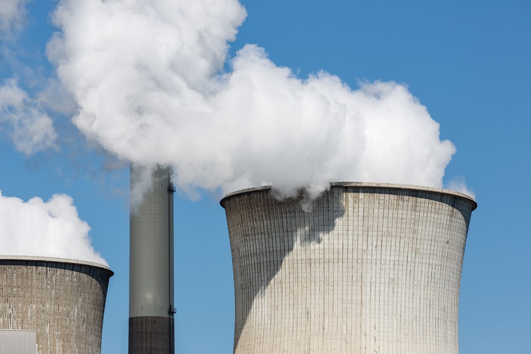 steam billowing from smoke stack at nuclear power station