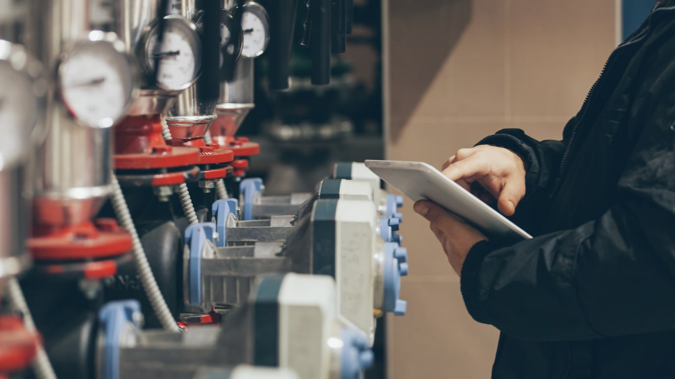 engineer-taking-measurements-boiler-room