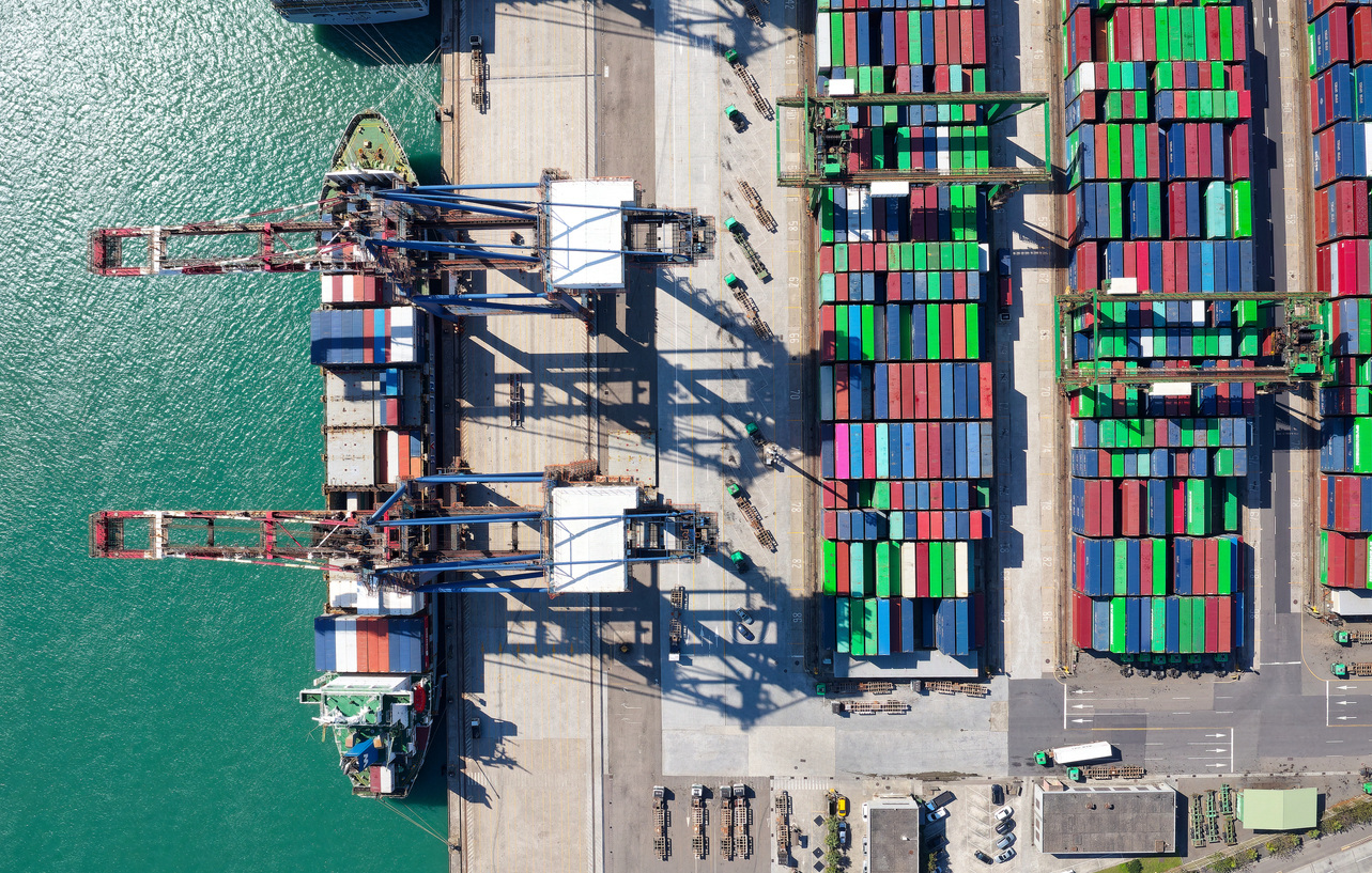 overhead image of shipping containers at a port