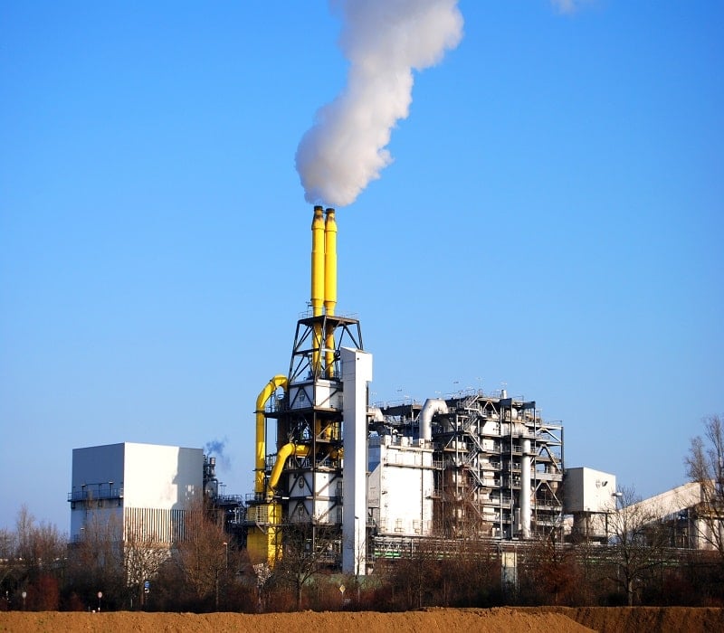 incineration plant with smoke coming from smokestack on a clear day