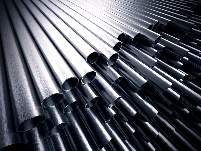 stack of gleaming stainless steel tubes against a black backdrop